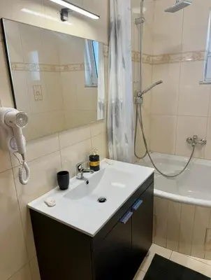 a bathroom with a sink and a shower at Serenity apartment sea view in Souda