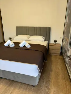 a bedroom with a large bed with two towels on it at Serenity apartment sea view in Souda