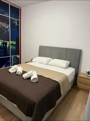 a bedroom with a large bed with towels on it at Serenity apartment sea view in Souda