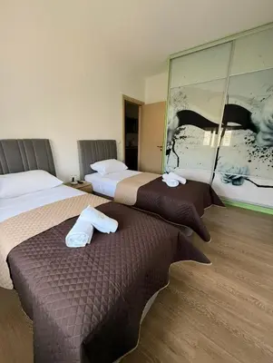 two beds sitting next to each other in a room at Serenity apartment sea view in Souda