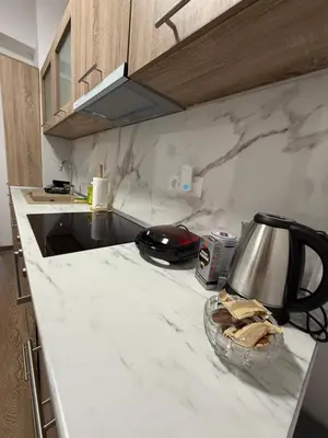 a kitchen counter top with a bowl of bread on it at Serenity apartment sea view in Souda