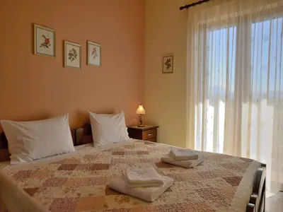 a bedroom with a bed with two towels on it at Niriides Apartments in Kissamos