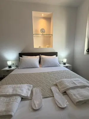 a bedroom with a large bed with two towels on it at Casa di Keti in Chania Town