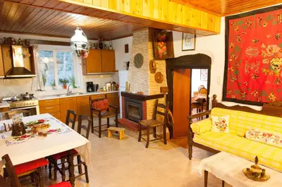 a kitchen and living room with a couch and a table at Villa Olea-Renieri in Grigorianá