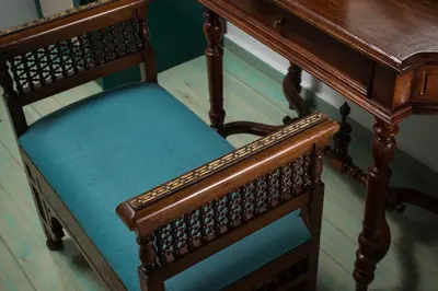 a wooden chair with a wooden table with a blue seat at Dream Art Studios in Chania Town