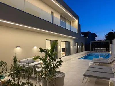 a villa with a swimming pool and a house at Sea Princessa Villa in Chania Town