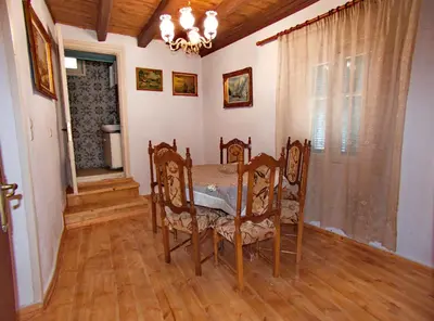 a dining room with a table and chairs and a window at Polidoros vintage house 13 km from Elafonisi in Vathi
