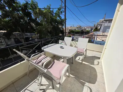 a patio with a table and chairs on a balcony at Olive Angel 1 in Chania Town