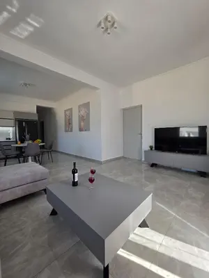 a living room with a table and a couch at Olive Angel 1 in Chania Town