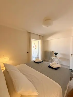 a bedroom with a large bed and a window at Chania Memories Apartment in Chania Town
