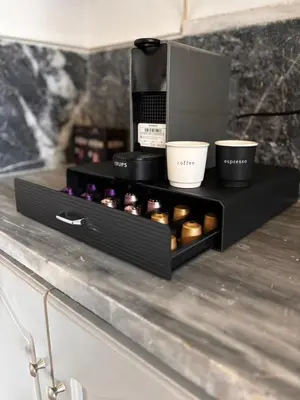 a black shelf with several cups on a counter at Yellowstone Chania in Chania Town