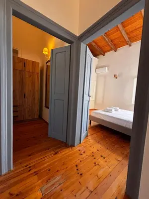 a room with a bed and an open door at Yellowstone Chania in Chania Town