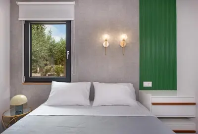 a bedroom with a bed and a window at Glafkos house with pool near the beach in Daratso