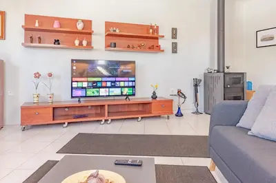 a living room with a tv and a couch at Sylvie Comfort Living in Chania Town
