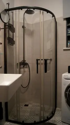 a shower with a glass door next to a sink at Sylvie Comfort Living in Chania Town