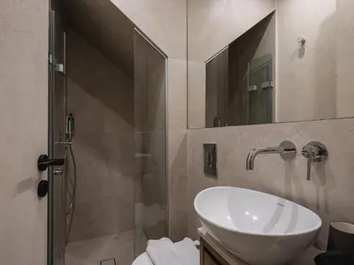a bathroom with a sink and a shower at Off Apartments in Chania Town