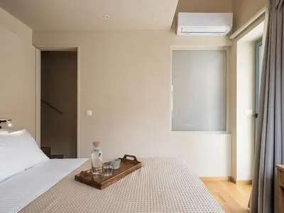 a bedroom with a bed and a tray with glasses on it at Off Apartments in Chania Town