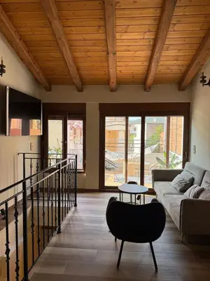 a living room with a couch and a table at Stay near Balos & the seaside in Kaloudhianá