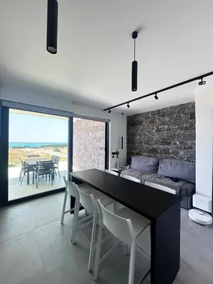 a living room with a black table and chairs at Astrokastro Frangokastello in Frangokastello