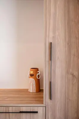 a mug sitting on a shelf in a cabinet at Aurea Beach Villa in Kato Daratso