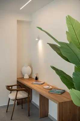 a wooden desk in a room with a plant at Aurea Beach Villa in Kato Daratso