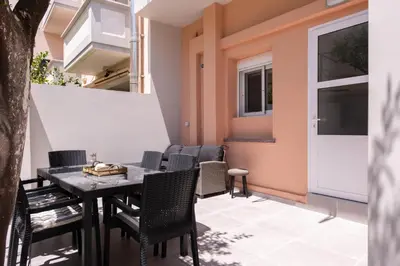 a patio with a table and chairs on a balcony at Apanemia Apartment in Chania Town