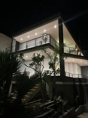 a building with stairs and a balcony at night at Casa Ansia Luxury Living 50m from the Beach in Stalos