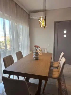 a dining room with a wooden table and chairs at Casa Ansia Luxury Living 50m from the Beach in Stalos