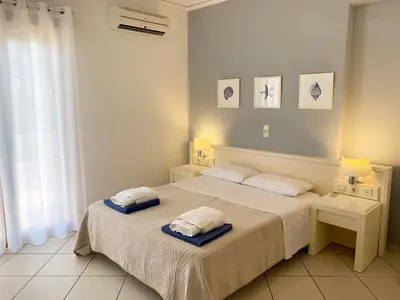 a bedroom with a bed with two pillows on it at Platanias Memories Studio 3 in Plataniás