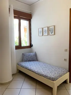 a bed sitting in a room with a window at Platanias Memories Studio 3 in Plataniás