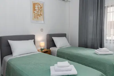 two beds sitting next to each other in a room at Lemon Tree Chania in Chania Town