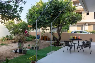 a patio with a table and chairs in a yard at Lemon Tree Chania in Chania Town