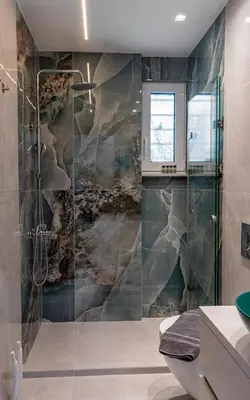 a bathroom with a shower with a stone wall at Lemon Tree Chania in Chania Town