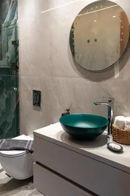 a bathroom with a green bowl sink on a counter at Lemon Tree Chania in Chania Town