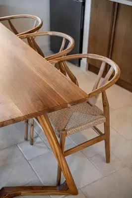 a wooden chair sitting next to a kitchen at Armenaki Residence in Arménoi
