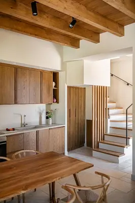 a kitchen with wooden cabinets and a wooden table at Armenaki Residence in Arménoi