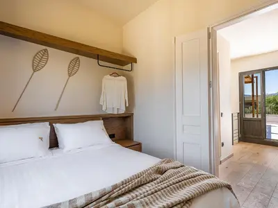 a bedroom with a white bed and a window at Armenaki Residence in Arménoi