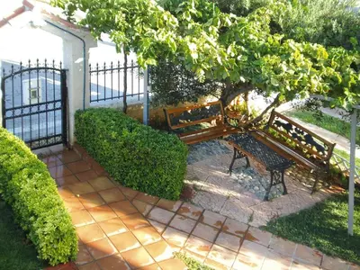 a bench sitting under a tree next to a fence at Holiday home, Marathokefala near Kolimbari in Marathokefála