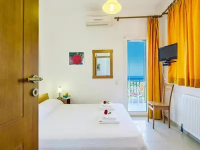a bedroom with a bed and a view of the ocean at Holiday home, Marathokefala near Kolimbari in Marathokefála