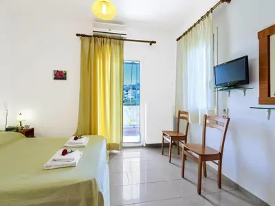 a hotel room with a bed and a table and chairs at Holiday home, Marathokefala near Kolimbari in Marathokefála