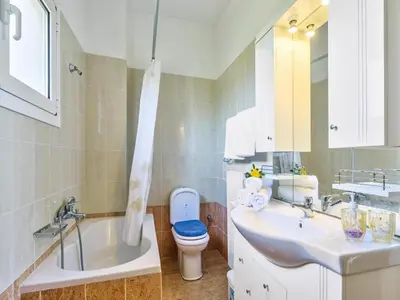 a bathroom with a tub and a toilet and a sink at Holiday home, Marathokefala near Kolimbari in Marathokefála