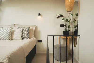 a bedroom with a bed and a table with a potted plant at Old Town Apt, Balcony, brand new, family, central in Chania Town