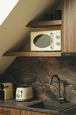 a microwave sitting on a shelf above a kitchen sink at Old Town Apt, Balcony, brand new, family, central in Chania Town