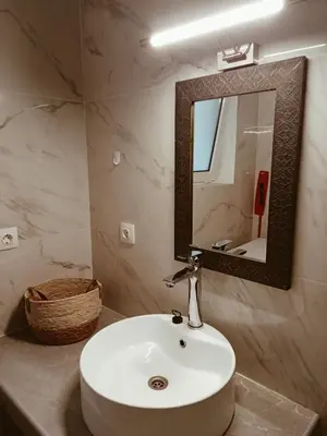 a bathroom with a white sink and a mirror at andys house in Chania
