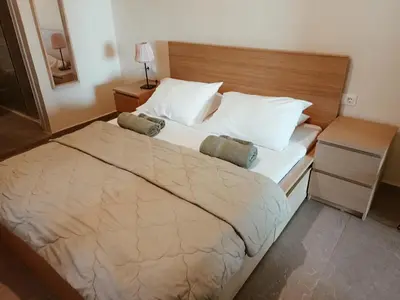 a bedroom with a large bed with two pillows at andys house in Chania