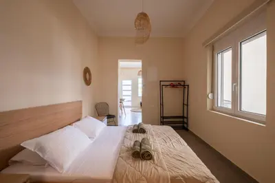 a bedroom with a large bed with shoes on it at andys house in Chania