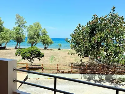 a view of a beach with the ocean in the background at Fifty Shades of Blue 10 sec to sea 5PL 2BD 2BA in Stalos