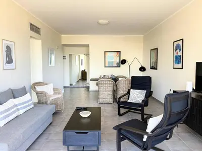 a living room with a couch and chairs at Fifty Shades of Blue 10 sec to sea 5PL 2BD 2BA in Stalos