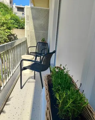 two chairs and a table on a balcony at Kalliso City Apartment near the beach in Chania Town