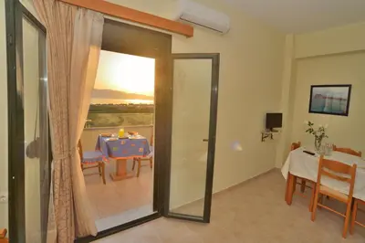 a room with a table and a dining room at Xenios Zeus Apartments in Kissamos